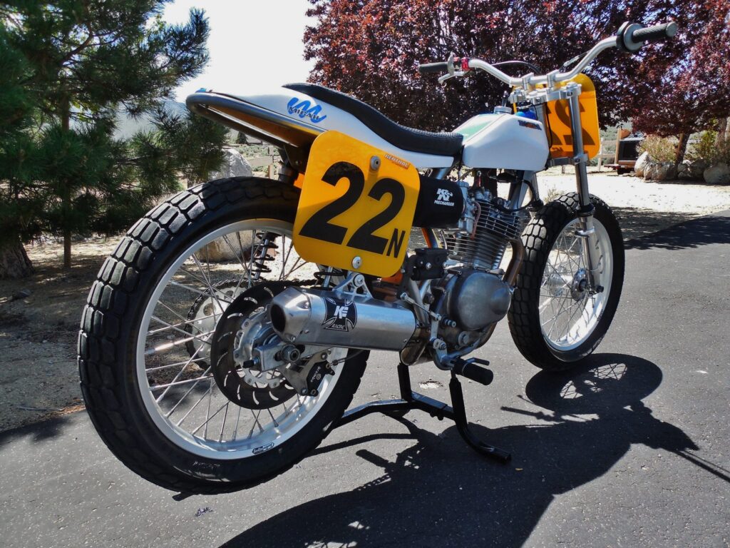The number 22 flat tracker from the front three-quarter, chrome bars and spoked wheels